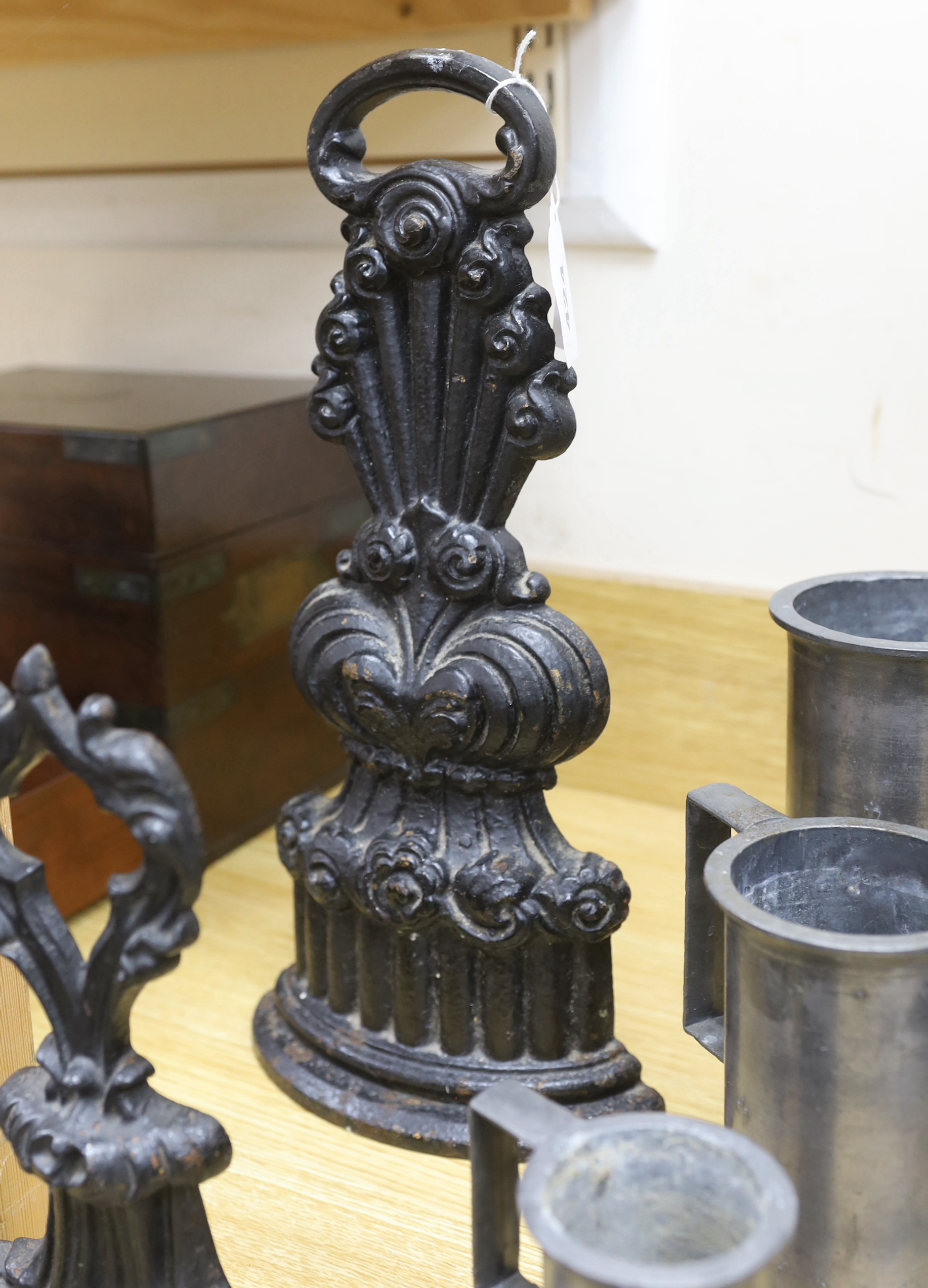 A graduated set of seven French pewter measures, a toleware spice box and two cast iron door stops (10), tallest door stop 39cms high